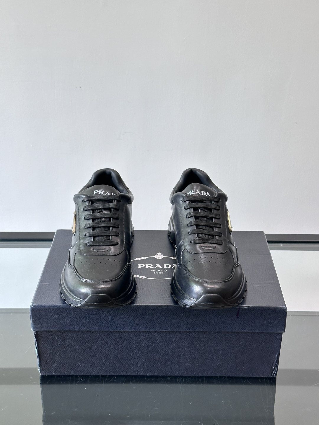 Prada Triangle Plaque Low-Top Sneakers — front